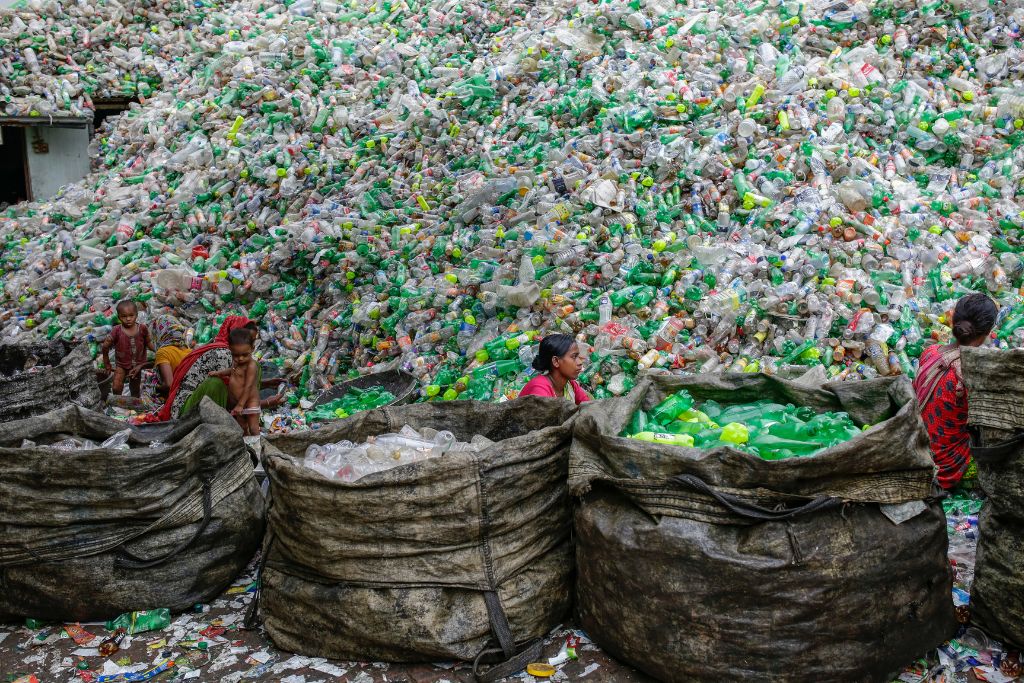 Female workers sort out plastic bottles for recycling in a factory in Dhaka, Bangladesh 26 October 2016.
