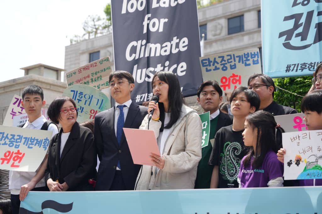 Plaintiff speaking at a press conference ahead of the first public hearing held on April 23, 2024.