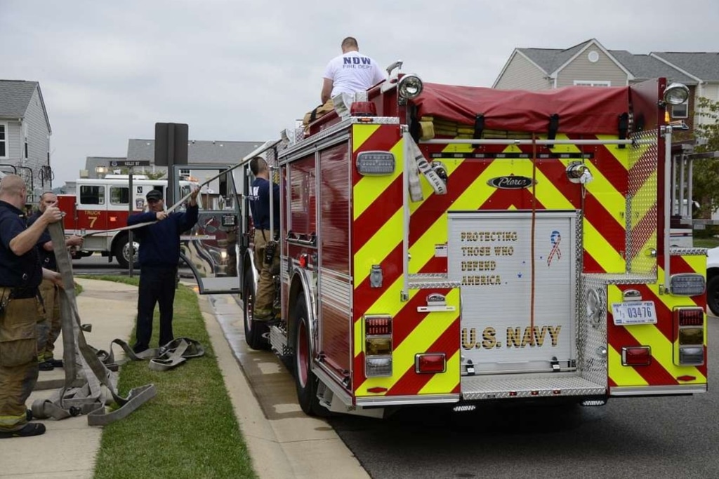 Firefighters from Naval District Washington Fire and Emergency Services (NDW F&ES), DC Fire and EMS respond to an emergency in Washington, DC.